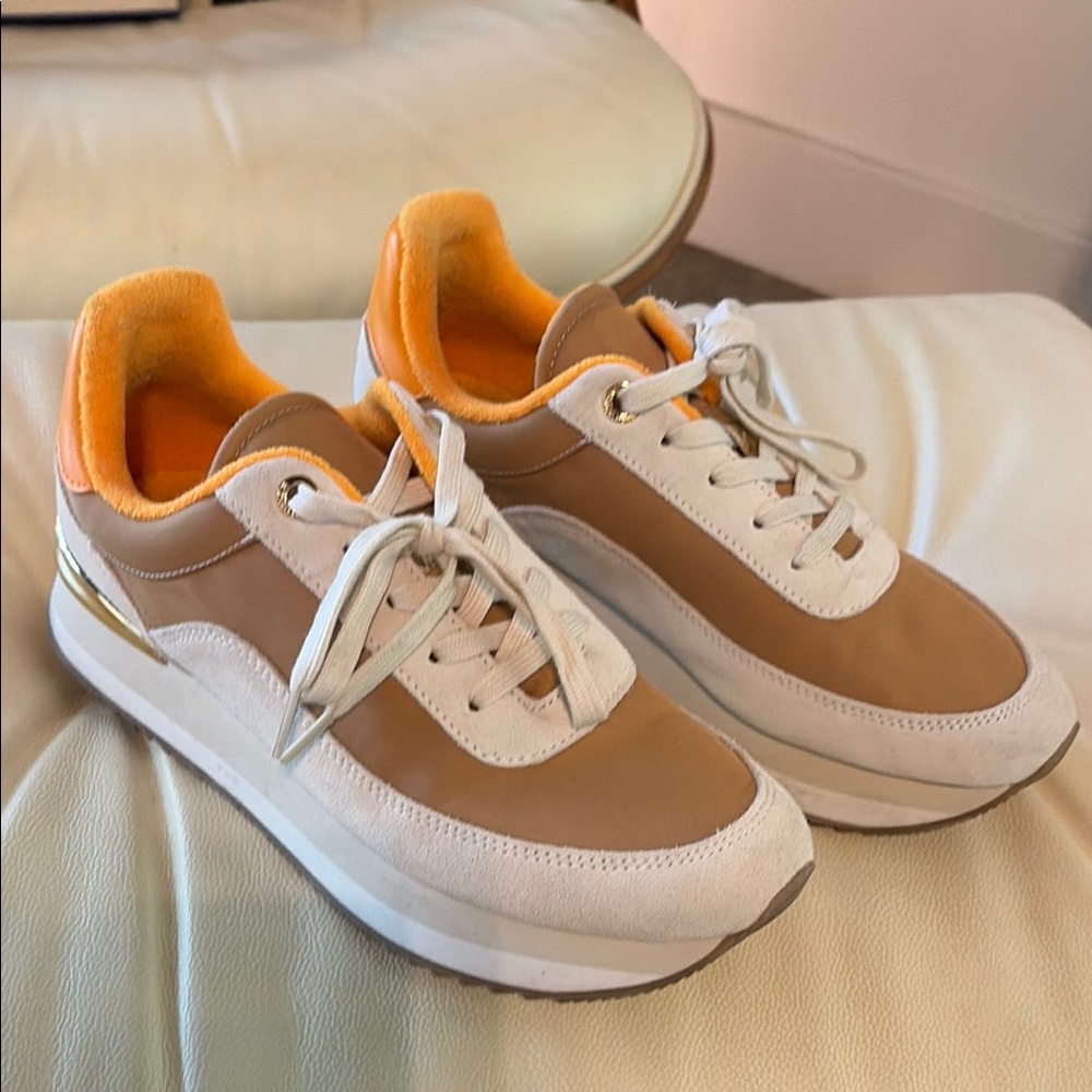 Stylish White and Tan Sneakers with Orange Accents